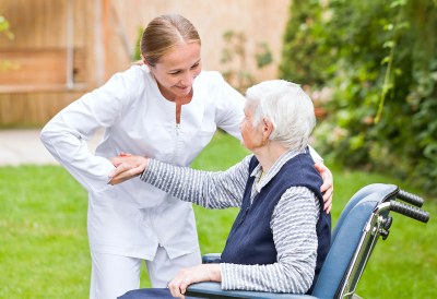 Photo of young carer helping the elderly woman